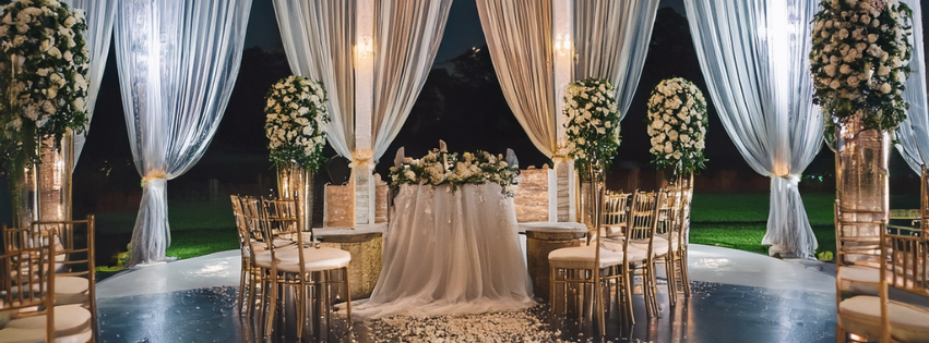 Maldives wedding setup on water villa deck with white roses and linen canopy